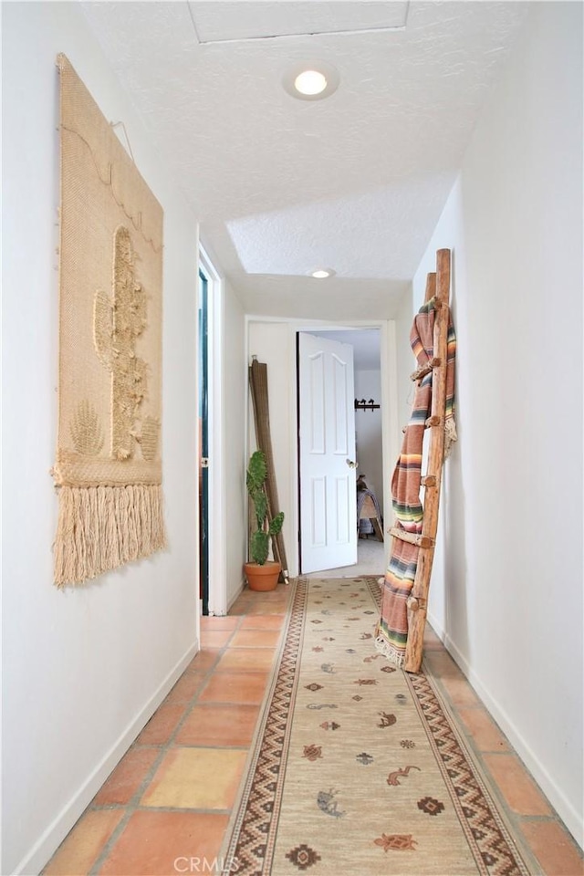 hallway with a textured ceiling