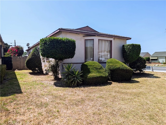 view of side of home with a lawn