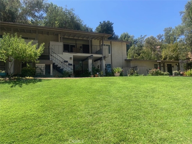 rear view of house with a yard