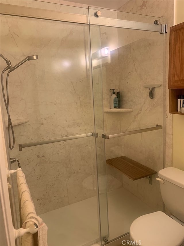 bathroom with walk in shower and toilet