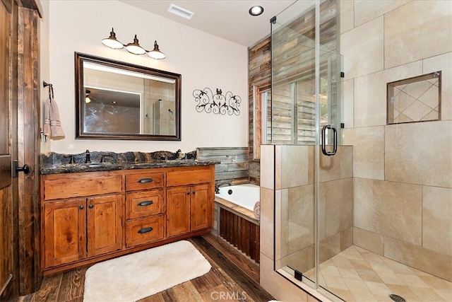 bathroom with shower with separate bathtub, vanity, and hardwood / wood-style flooring