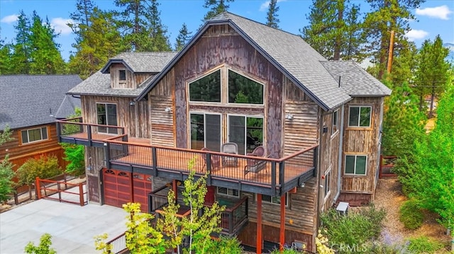 rear view of property with a garage