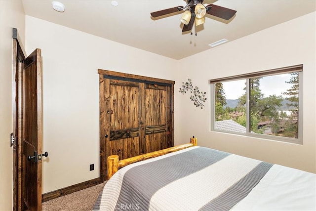 bedroom with ceiling fan and carpet