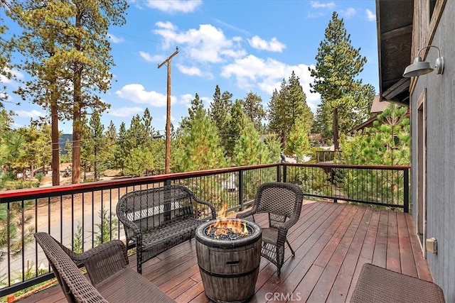 wooden terrace featuring a fire pit