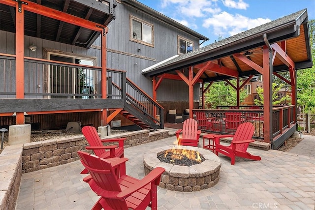 view of patio / terrace with a gazebo, a deck, and a fire pit