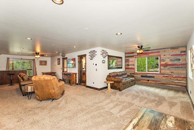 carpeted living room with ceiling fan