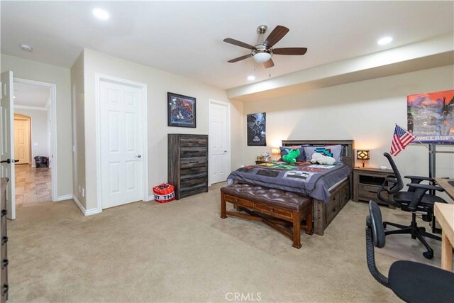 bedroom featuring light carpet and ceiling fan