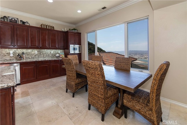 dining area featuring crown molding