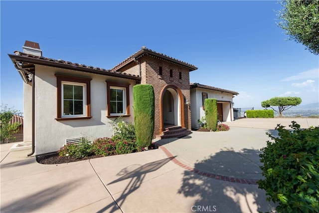 mediterranean / spanish-style home featuring a garage