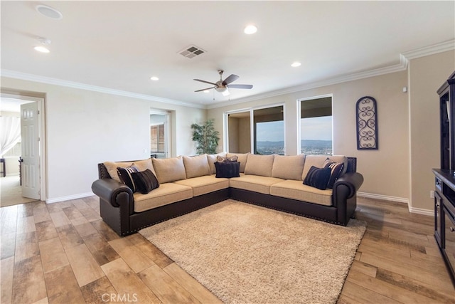 living room featuring light hardwood / wood-style floors, crown molding, and ceiling fan