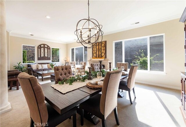 carpeted dining room featuring a notable chandelier, ornamental molding, and a healthy amount of sunlight