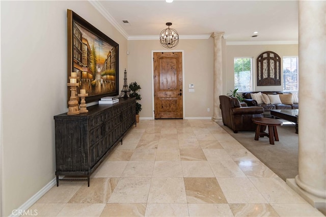 entrance foyer with ornate columns, ornamental molding, and an inviting chandelier