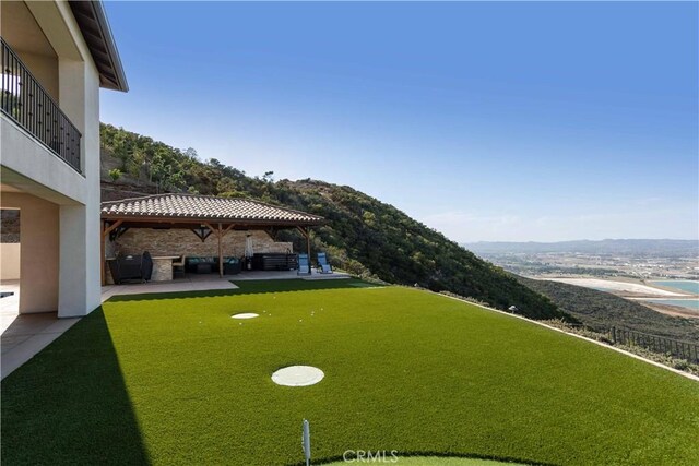 view of yard with a balcony and a patio area