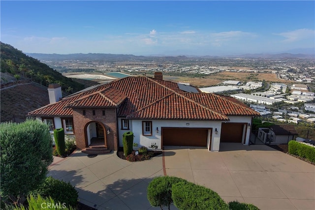 mediterranean / spanish home featuring a mountain view and a garage