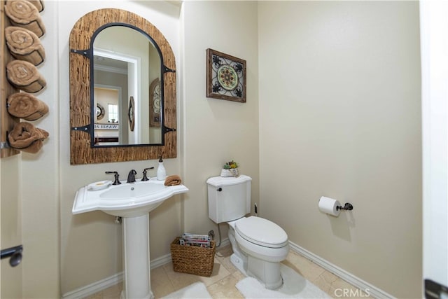 bathroom with sink, tile patterned flooring, and toilet