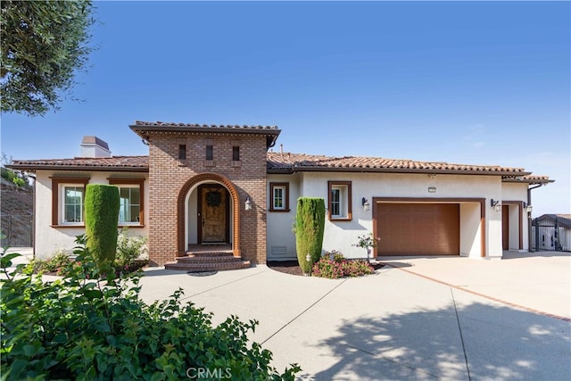 mediterranean / spanish-style house featuring a garage