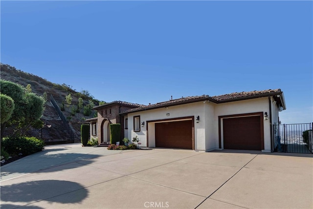 mediterranean / spanish-style house with a garage