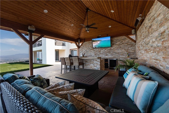 view of patio featuring outdoor lounge area, a mountain view, and ceiling fan