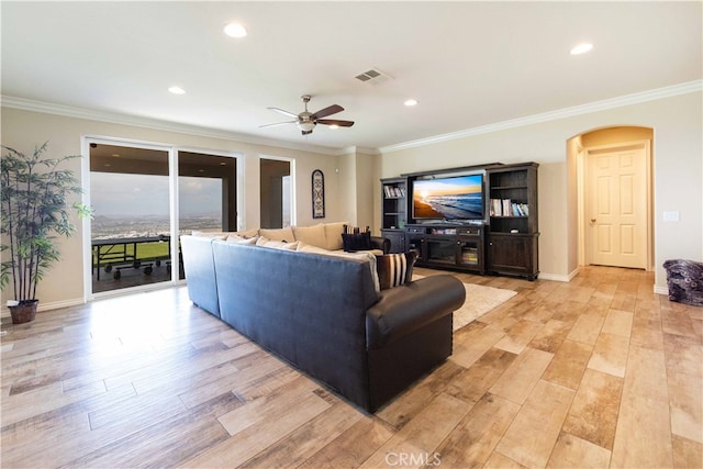 living room featuring ceiling fan, light hardwood / wood-style flooring, and ornamental molding