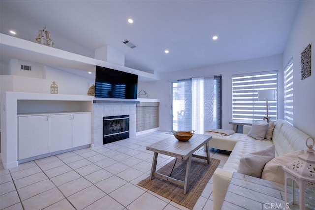 tiled living room featuring lofted ceiling and a fireplace