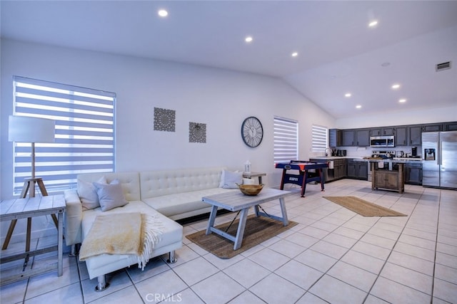 living room featuring lofted ceiling and light tile patterned floors