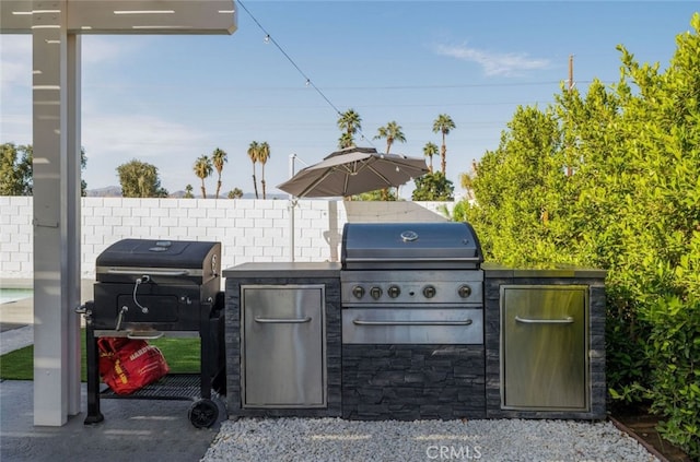 view of patio with area for grilling and exterior kitchen