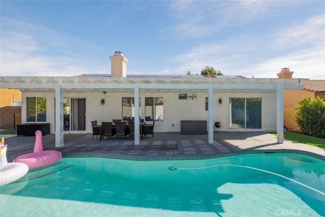 view of pool with a patio and a pergola