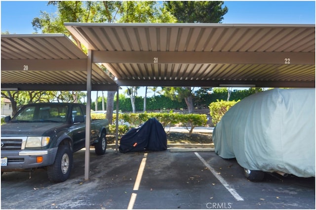 view of parking / parking lot featuring a carport