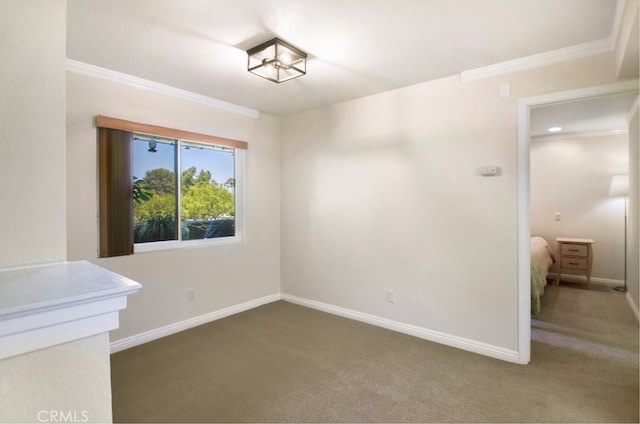 carpeted spare room with crown molding