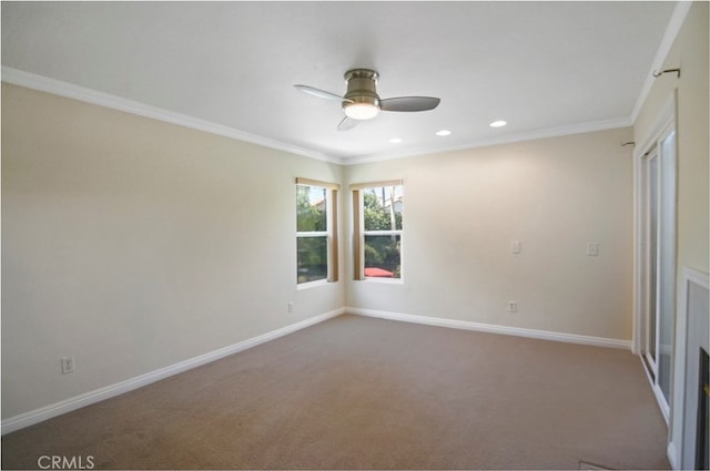 spare room featuring ornamental molding, ceiling fan, and carpet floors