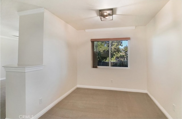 carpeted spare room with ornamental molding