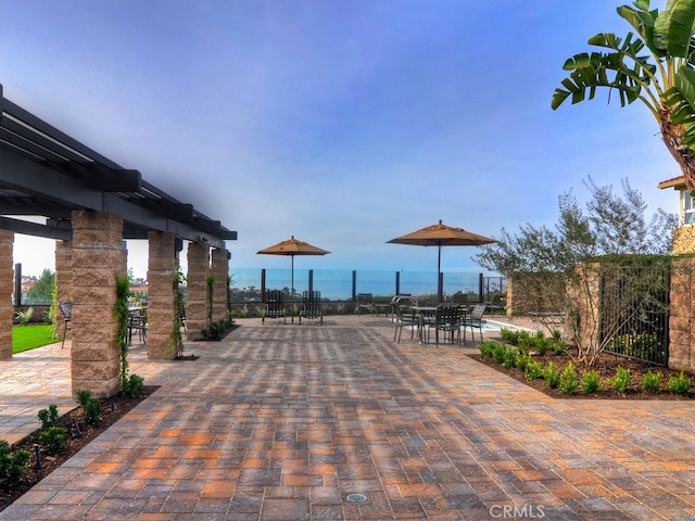 view of property's community with a water view and a patio area