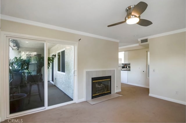 unfurnished living room with carpet, crown molding, ceiling fan, and a high end fireplace