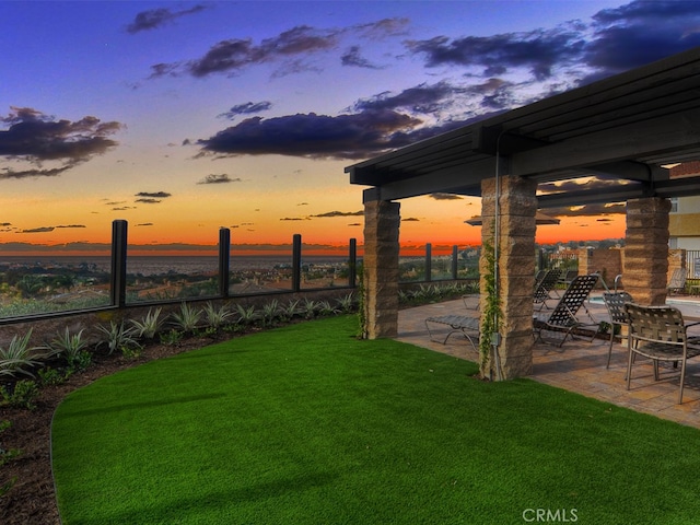 yard at dusk with a patio