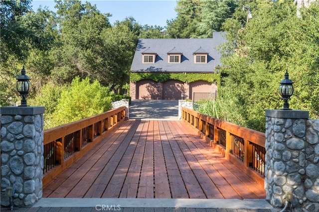 wooden terrace featuring a garage