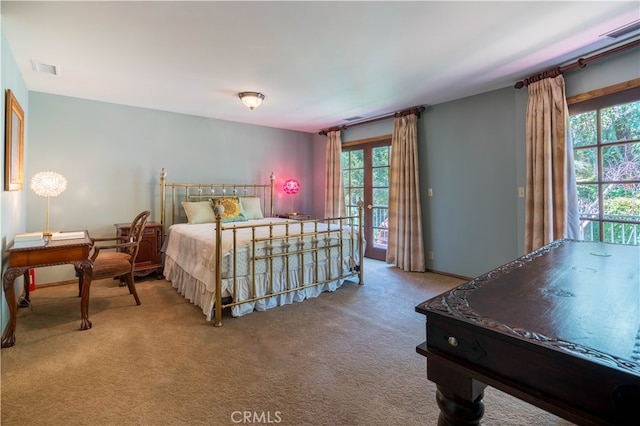 carpeted bedroom featuring french doors, access to exterior, and multiple windows