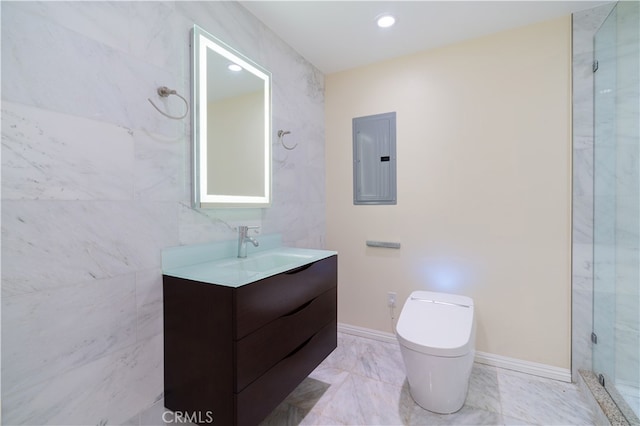 bathroom with tile walls, electric panel, vanity, walk in shower, and toilet