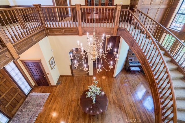 foyer entrance featuring a notable chandelier, a high ceiling, and hardwood / wood-style flooring