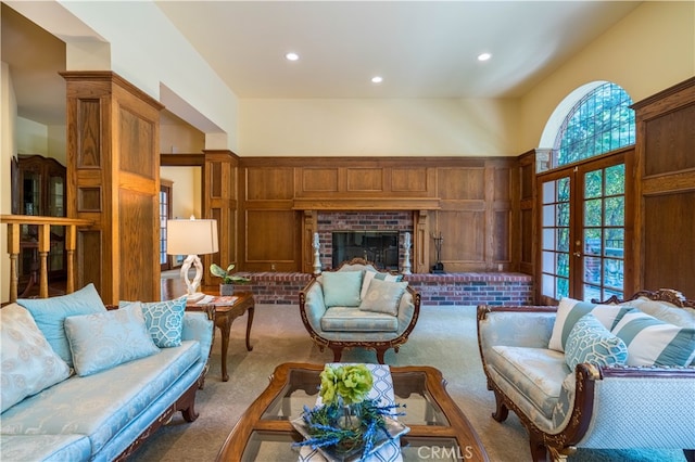 carpeted living room with french doors and a fireplace