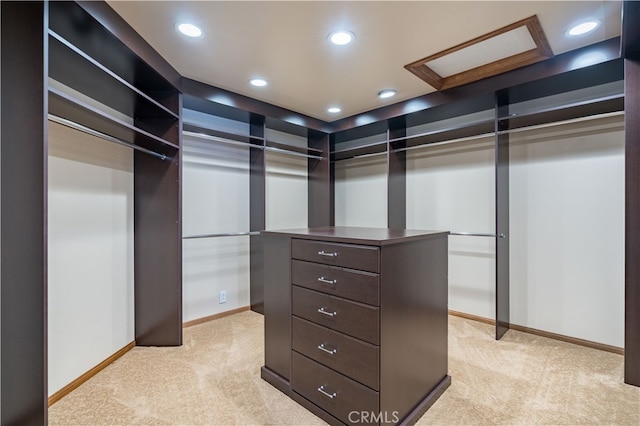 walk in closet featuring light colored carpet