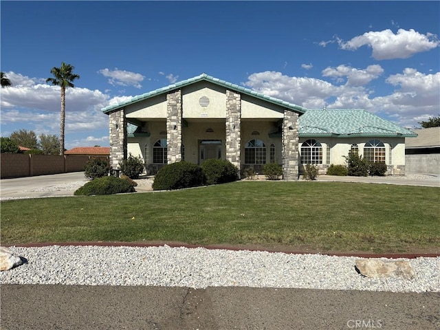 view of front of house featuring stone siding, a front lawn, and stucco siding