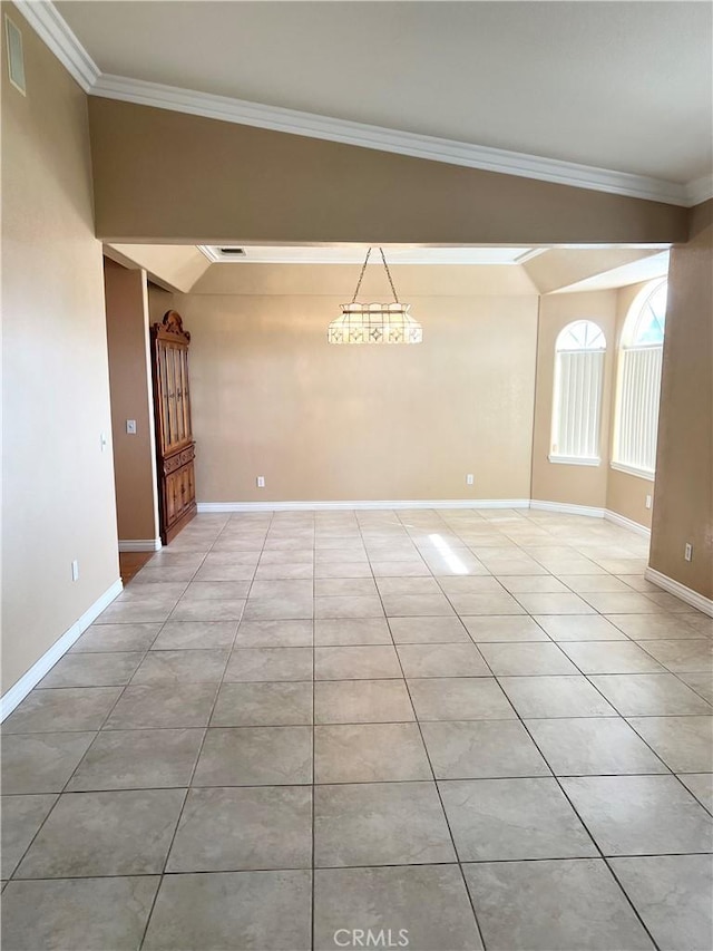 spare room with ornamental molding, baseboards, and light tile patterned floors