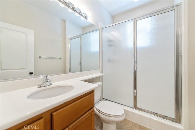 bathroom with tile patterned flooring, vanity, toilet, and a shower with door