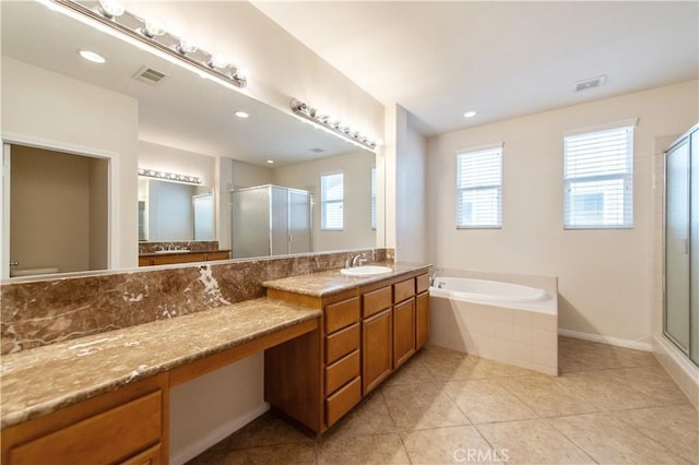 bathroom featuring tile patterned flooring, a healthy amount of sunlight, and independent shower and bath