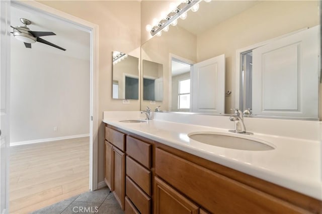 bathroom with ceiling fan, vanity, and wood-type flooring