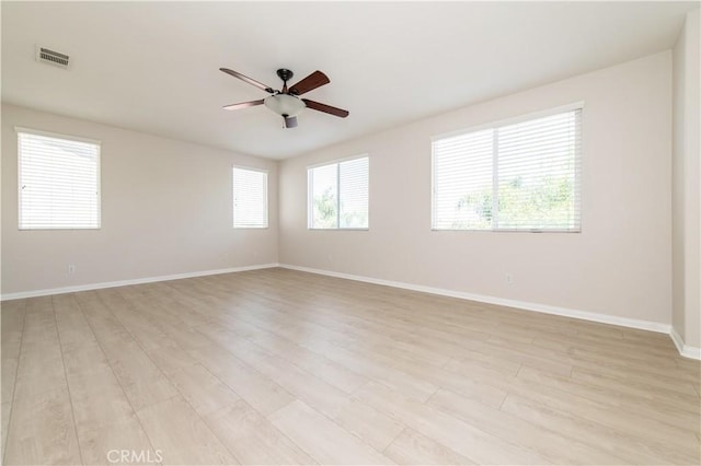 empty room featuring light hardwood / wood-style flooring and ceiling fan