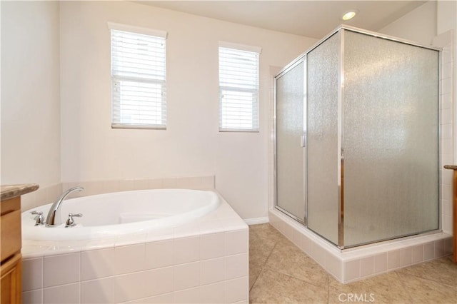 bathroom with tile patterned floors, vanity, and plus walk in shower