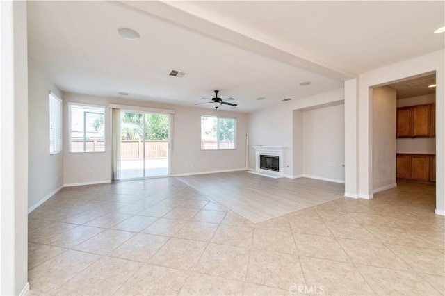 unfurnished living room with ceiling fan and light tile patterned floors