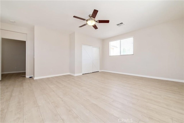 empty room featuring light wood-type flooring and ceiling fan