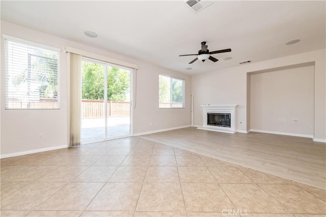 unfurnished living room with light wood-type flooring and ceiling fan